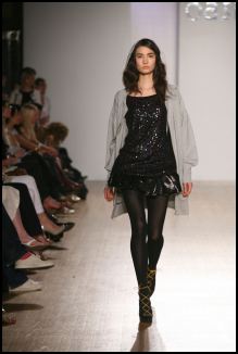 Evening wear mixed with thick black tights  at Oasis.