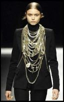 Givenchy skinny trousers, severe jacket and lots of metal hardware, crucifixes and chains.  