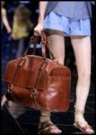 Blue shorts and rich dark tan leathe holdall designer bag from D&G