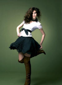 White short sleeved blouse �25 with Puff ball skirt �28. Colours available: Black and pink. Leather tie sash �18.