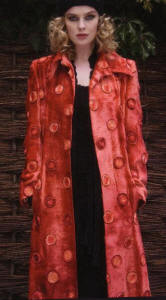 This wonderful red velvet coat by Avoca Anthology is covered in ribbon circular sunburst decorative embellishment arrangements.