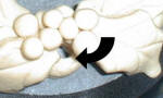 Make a hole in the dough to loop your ribbon.