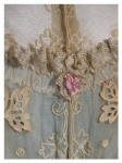 Detail of dress back bodice lace with rose trim.