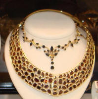  Bohemian garnet jewellery - a garnet encrusted torque necklace and a garnet  necklet.