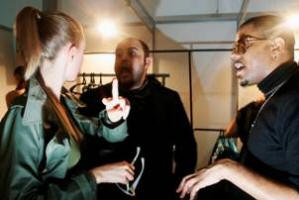 James Campbell and BJ Coleman are giving directions to their model Baby Phat models waiting for the show to start.