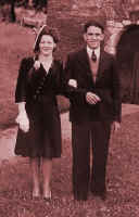 Photograph of guests at a wedding in 1945. 1940s fashion history and costume history.