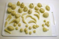 Moulded marzipan fruits before colour decoration.