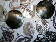 Here natural freshwater pearls are embedded in the natural shell and the pendant is carved from the shell to incorporate the pearl. 