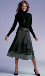 A similar soft look from NEXT Directory. Deep Waist Roll Neck Sweater in Black is �14.99.  No. 102-207-X38.  Grey Circle Skirt is �29.99.  No. 109-809-X38.