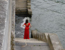 Lady in red on the steps at the banks of the River Sine in Paris Summer 2006