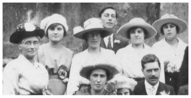 The women also wear fashionable hats of the early 1920s