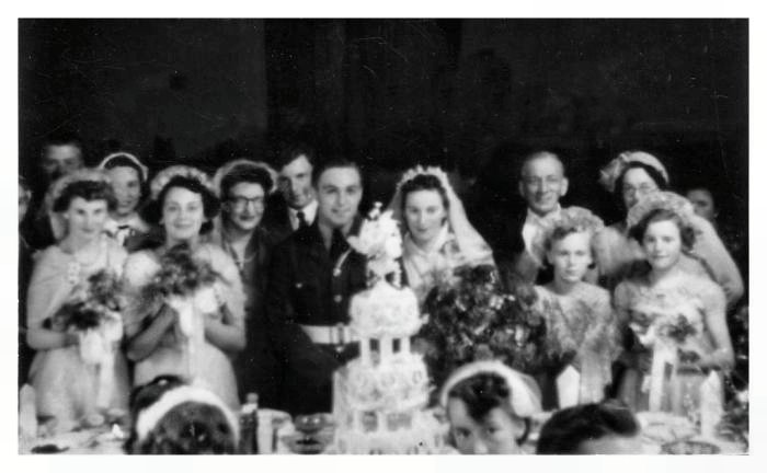 The bridal party and the ornate wedding cake are pictured below