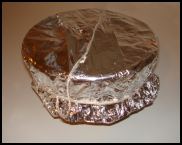 Xmas Pudding foil and paper on basin tightly secured with string
