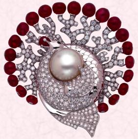 Luxury bespoke jewellery - The Héra clip is white gold set with diamonds, Burmese ruby spheres and all adorn a natural, button shaped mabe pearl (17.92 carats). Price on application to Van Cleef & Arpels.
