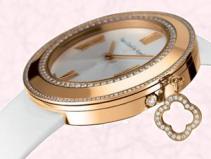 This Van Cleef & Arpels watch has a diamond Alhambra charm. The Alhambra motif is frequently used as a feature of timepieces.